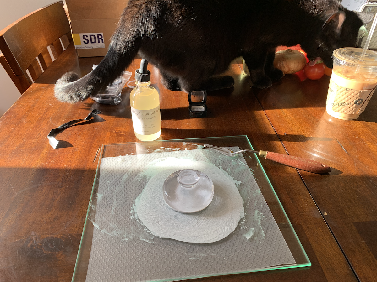 photo of pumagreg, my black cat, on the table and getting a little too close to my paint for comfort