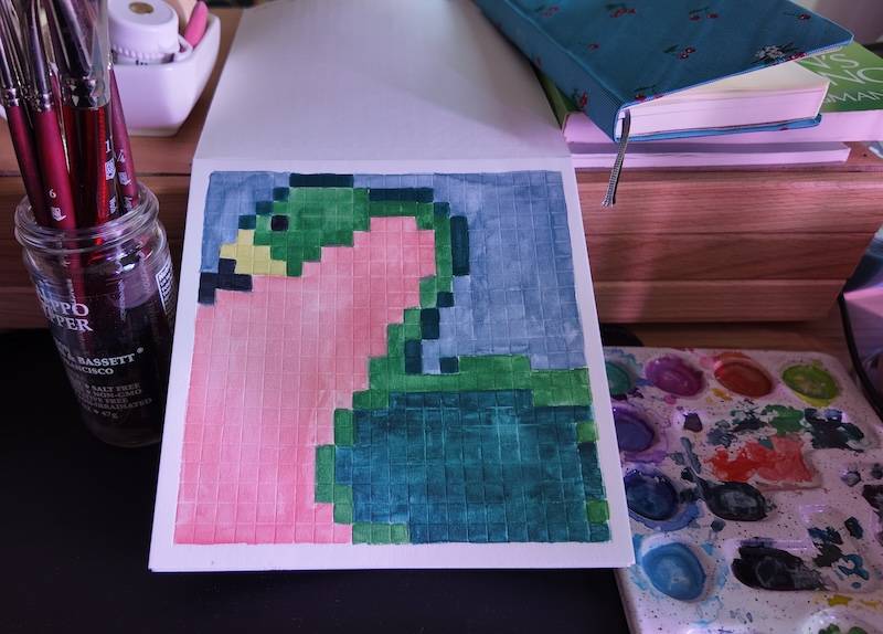 photo of pixel watercolor sketchbook on page 8, a pixel art flamingo but it's green