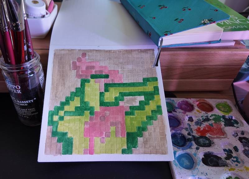photo of pixel watercolor sketchbook on page 11, a pixel figure drawing of a the back view of a woman with green skin and pink hair