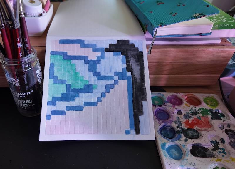 photo of pixel watercolor sketchbook on page 18, a pixel figure drawing of a woman soaking in the tub, she's got blue skin and black hair