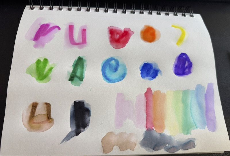photo of the same page of dr. sketch swatches except i used a watercolor brush and water to swirl the ink around and make little rainbow swatch
