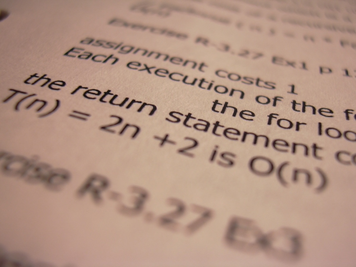 a weird artsy angle photo of some typed out algorithms assignment