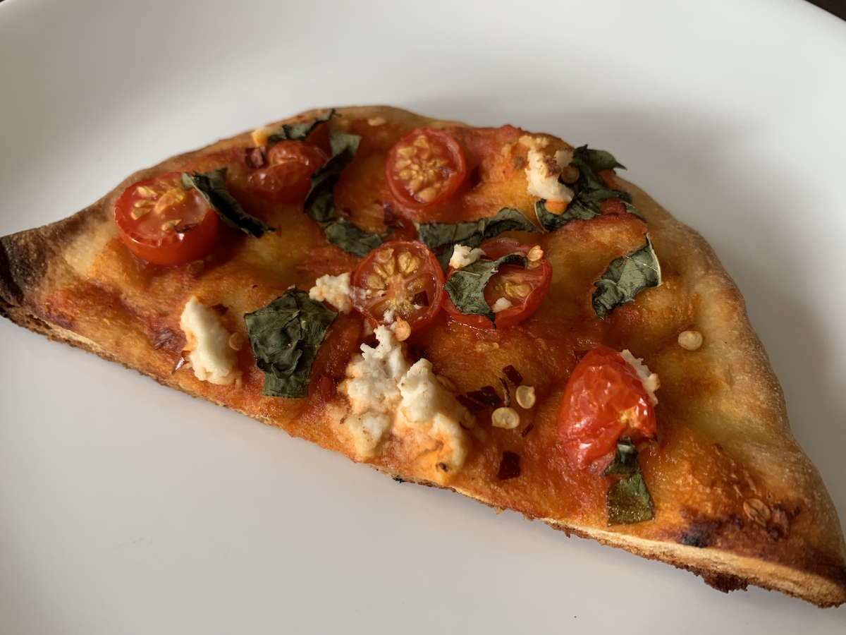 photograph of a slice of tomato flatbread