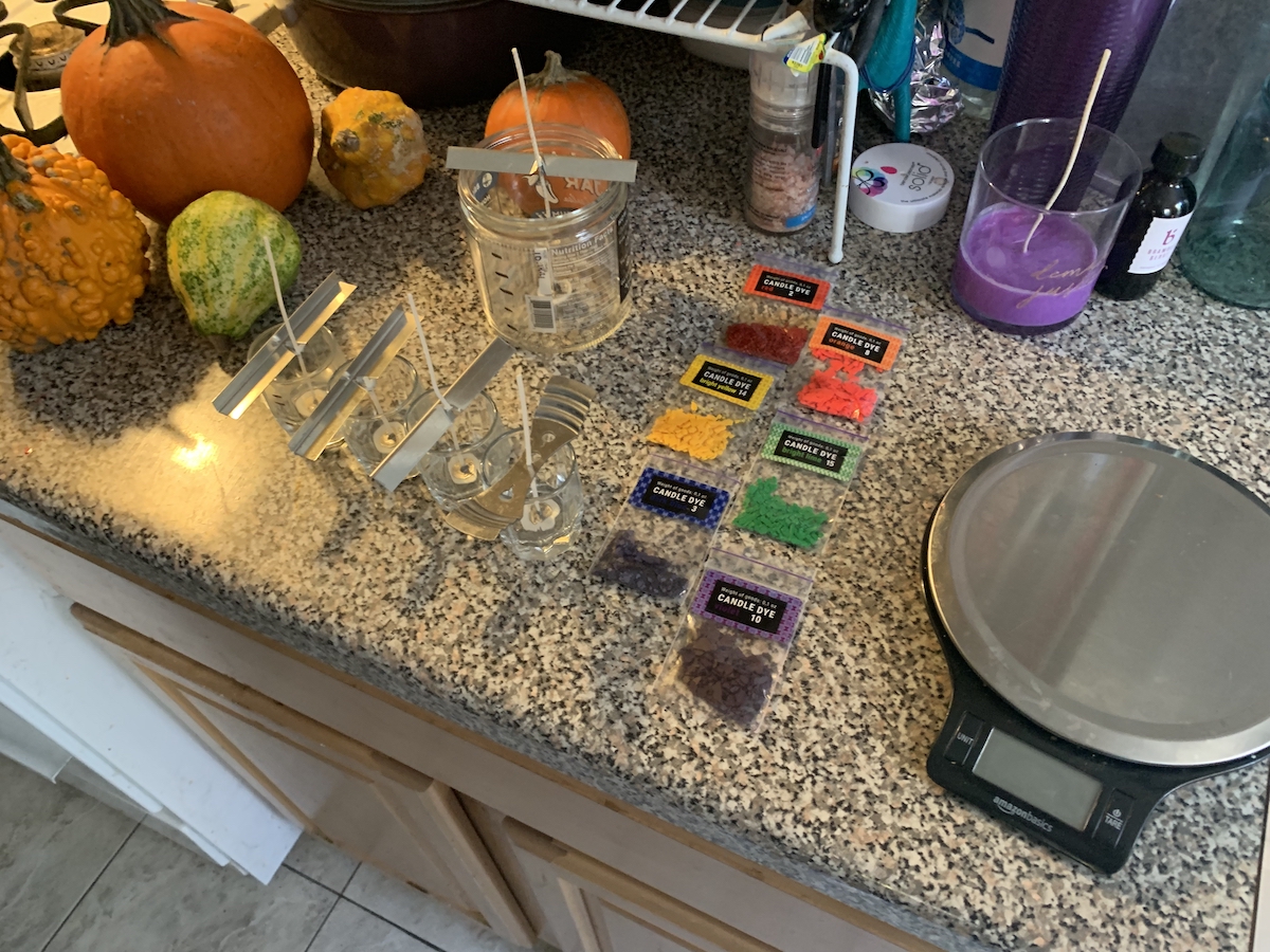 photograph of my kitchen counter showing all the glasses wicked, dyes and fragrance laid out