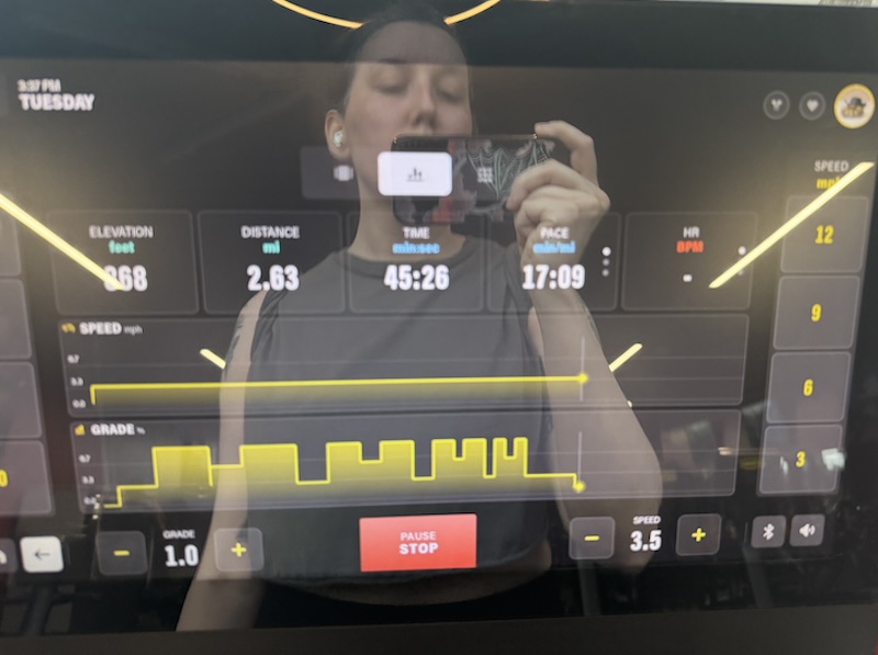 my reflection showing in the treadmill screen as i'm 45 minutes into my hour workout