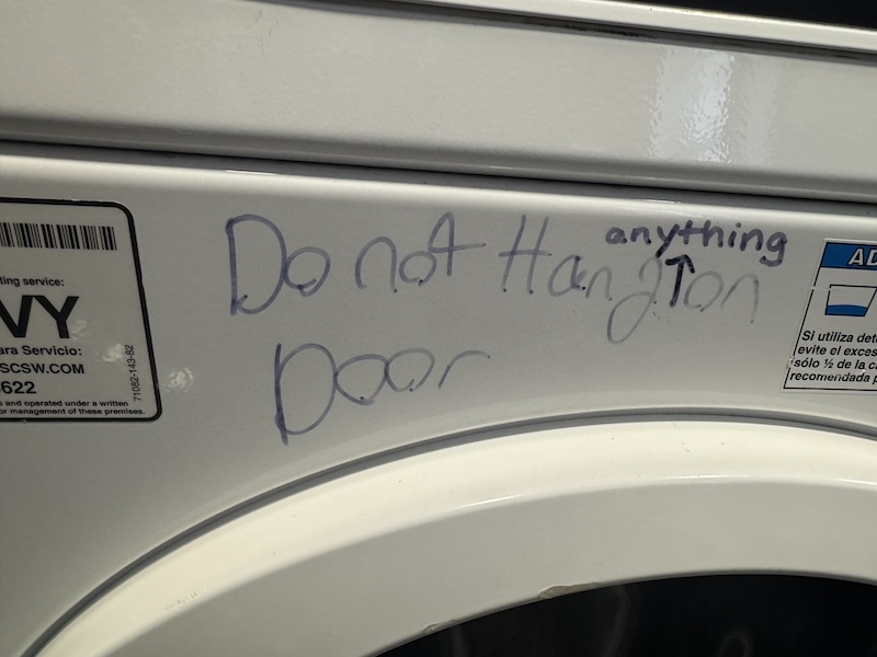a dryer with "do not hang on door" written on it and some dork put "anything" with an arrow pointing betweet "hang" and "on" as if we couldn't infer that on our own jfc