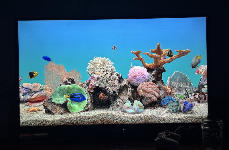 photo of my tv in a dark room showing the roku screensaver is an aquarium scene